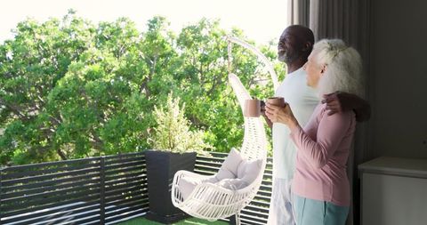 Senior Couple Enjoying Tranquil Balcony View Together