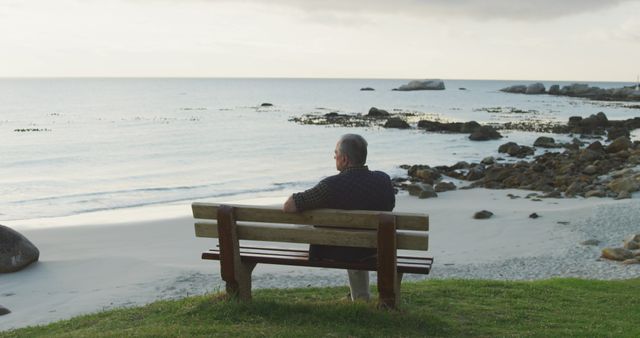 Senior Man Sitting on Beach Bench at Sunset, Reflecting and Relaxing - Download Free Stock Images Pikwizard.com