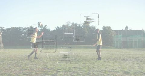 Male Soccer Players Heading Ball with Augmented Data Overlays for Performance Analysis