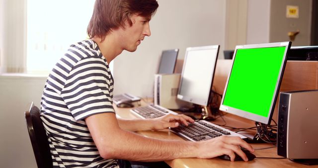 Young Man Using Computer in Modern Office Environment - Download Free Stock Images Pikwizard.com