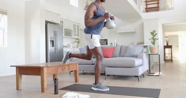 Man Doing Single-Leg Squats While Holding Kettlebell in Home - Download Free Stock Images Pikwizard.com