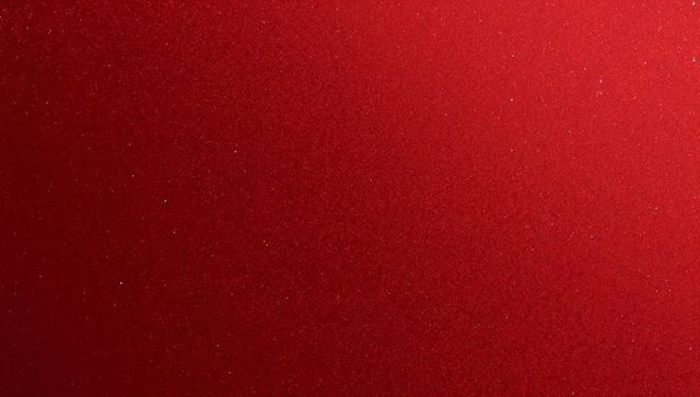 Crimson metallic surface shimmering with fine glitter and soft gradient highlights