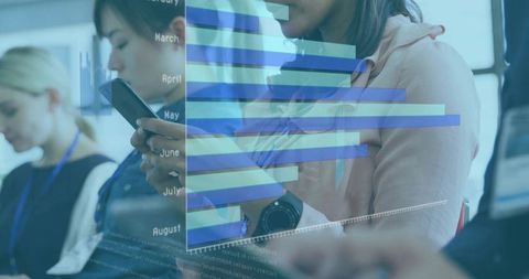 Professionals using mobile devices at conference with translucent data visualization overlay