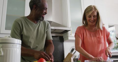 Happy Diverse Senior Couple Cooking Together in Kitchen