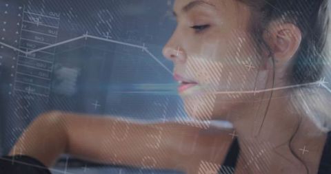 Focused woman analyzing digital data charts with virtual display