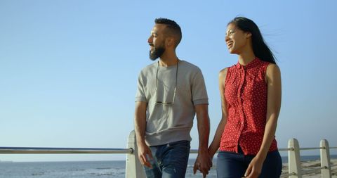 Happy Couple Walking Together on Sunny Seaside Promenade
