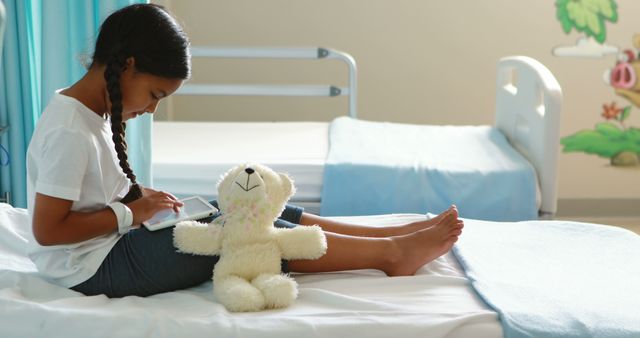 Young Girl Playing with Tablet in Childhood Hospital Ward - Download Free Stock Images Pikwizard.com