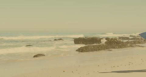 Couple Walking With Surfboards on Tranquil Beach