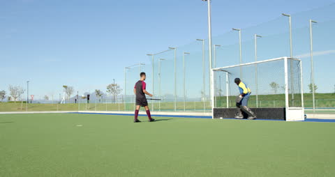 Goalie Mastering Skills on Sunny Hockey Field