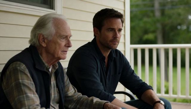 Contemplative father and adult son sitting on porch talking quietly, suburban moment