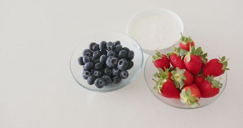 Fresh blueberries strawberries with yogurt on minimal counter
