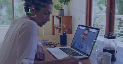Focused Woman Taking Online Meeting Notes in Home Office