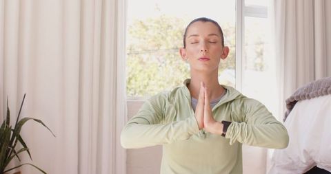 Woman Practicing Meditation at Home in Natural Light