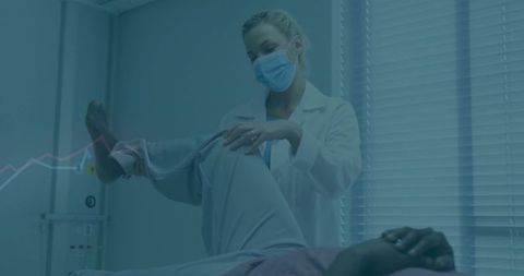 Healthcare professional assessing patient's knee mobility in medical office