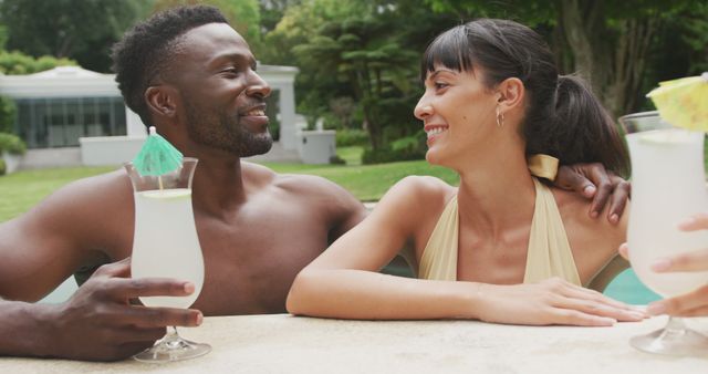 Relaxing Poolside with Refreshing Cocktails, Multicultural Couple Enjoying Vacation - Download Free Stock Images Pikwizard.com