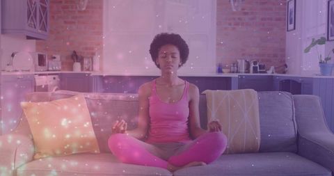 Serene Woman Meditating on Couch with Calm Atmosphere