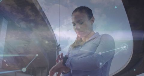 Woman using smartwatch in technological environment