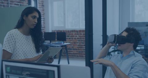 Colleagues Collaborating on Virtual Reality Technology in Modern Office