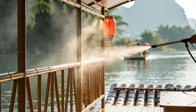 Morning mist spraying bamboo railing on riverside raft with red lantern and karst peaks