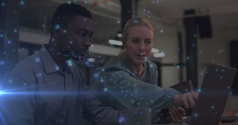 Diverse Coworkers Collaborating in Dark Office with Data Visual Effects