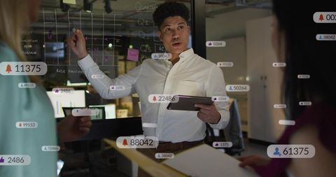 Business leader presenting strategy on glass board with analytics overlays and collaboration