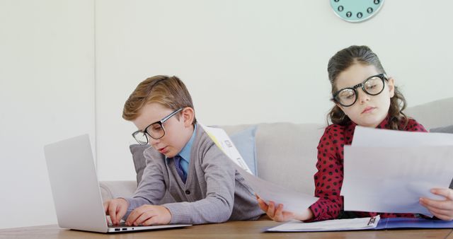 Children in Business Attire Working on Laptop and Documents at Home - Download Free Stock Images Pikwizard.com