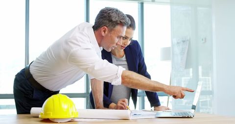 Architects Collaborating on Project with Laptop in Modern Office - Download Free Stock Images Pikwizard.com