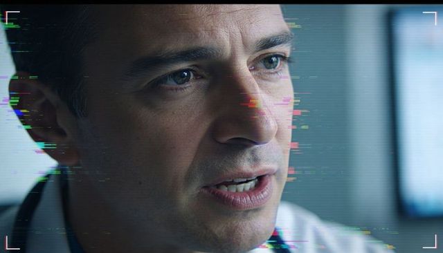 Mature doctor speaking with stethoscope in white coat with digital glitch overlay