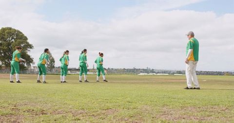 Diverse softball team preparing for outdoor practice