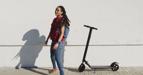Young Woman Standing Next to Scooter on Cityside Promenade - Download Free Stock Images Pikwizard.com
