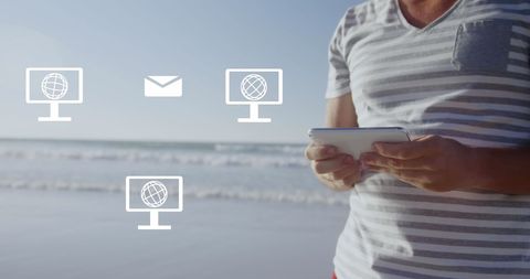 Man Holding Tablet by Ocean with Digital Communication Icons Overlay