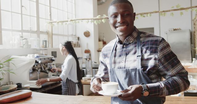 Smiling Barista Holding Coffee Cup in Trendy Café - Download Free Stock Images Pikwizard.com