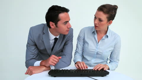 Professional Business Team Collaborating on Computer Task