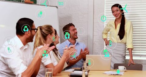 Businesswoman presenting sustainable energy strategy to applauding team in modern office