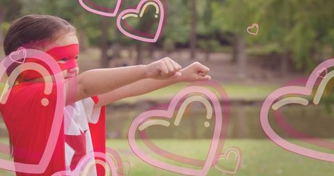 Empowered Child Superhero Flying with Heart Overlays Outdoors