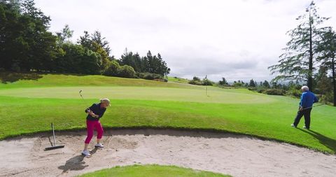 Senior Couple Enjoying Golf on Sunny Day