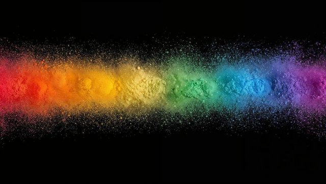 Vibrant spectrum of colored pigment powder exploding horizontally