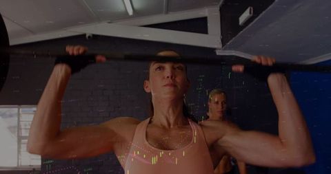Female Athlete Pressing Heavy Barbell Overhead in Industrial Gym With Spotter