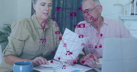 Senior Couple Analyzing Finances with Digital Interface Overlay