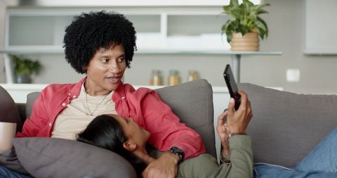 Diverse Couple Relaxing on Couch Sharing Quality Time