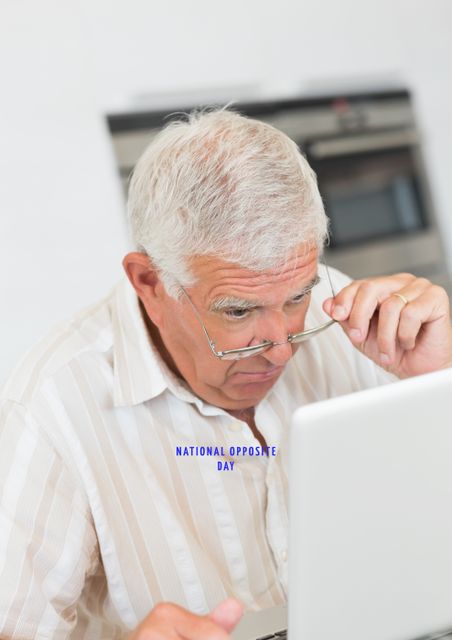 Curious Elderly Man Using Laptop Celebrating National Opposite Day - Download Free Stock Images Pikwizard.com