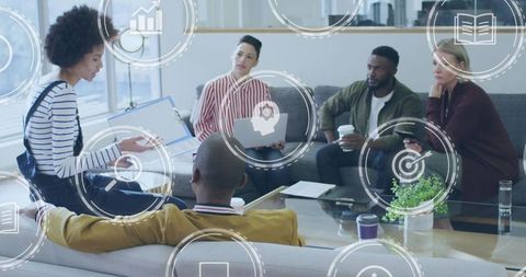 Woman Presenting in Modern Office Lounge Leading Collaborative Team Meeting with Tablet