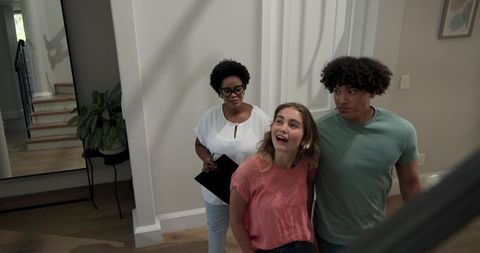 Realtor showing new home to excited young couple