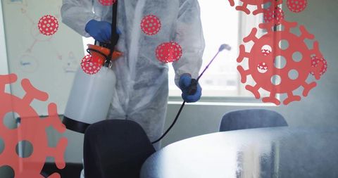 Misting conference room with fogging sprayer, ppe technician sanitizing office for virus