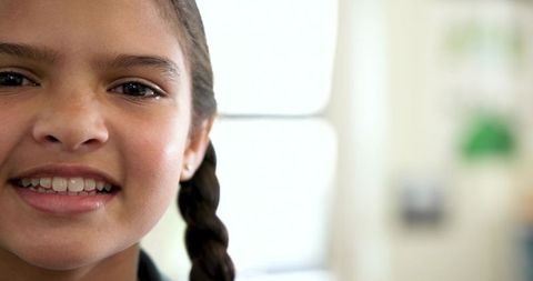 Portrait of Girl Smiling with Braid in Bright Room