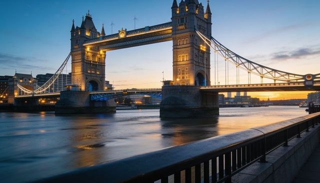 Glowing tower bridge at dusk spanning river thames, gothic towers reflecting in twilight