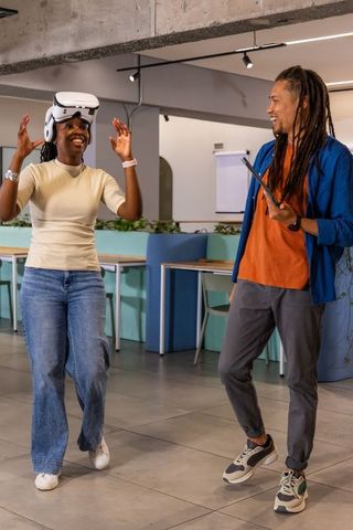 Coworkers collaborating with vr headset and tablet in modern coworking space