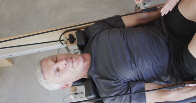 Senior Man Exercising Using Pilates Reformer Machine - Download Free Stock Images Pikwizard.com