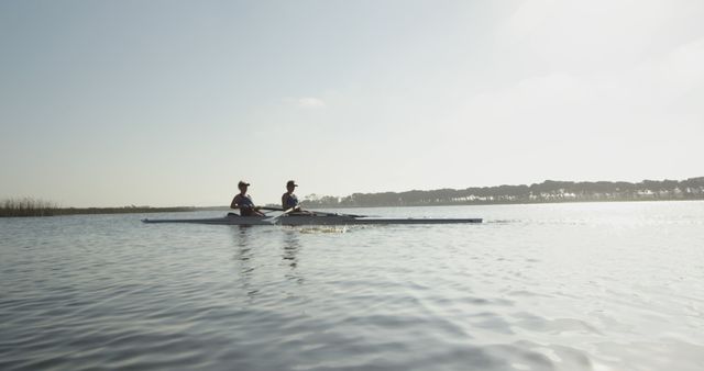 Two Women Rowing on Calm Lake During Daytime in Scenic Nature - Download Free Stock Images Pikwizard.com