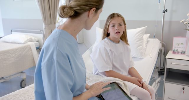 Nurse Consulting with Young Patient in Hospital Room - Download Free Stock Images Pikwizard.com